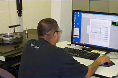 A Man Sitting in Front of a Computer