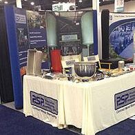 Trade show booth displaying industrial equipment and informational materials.